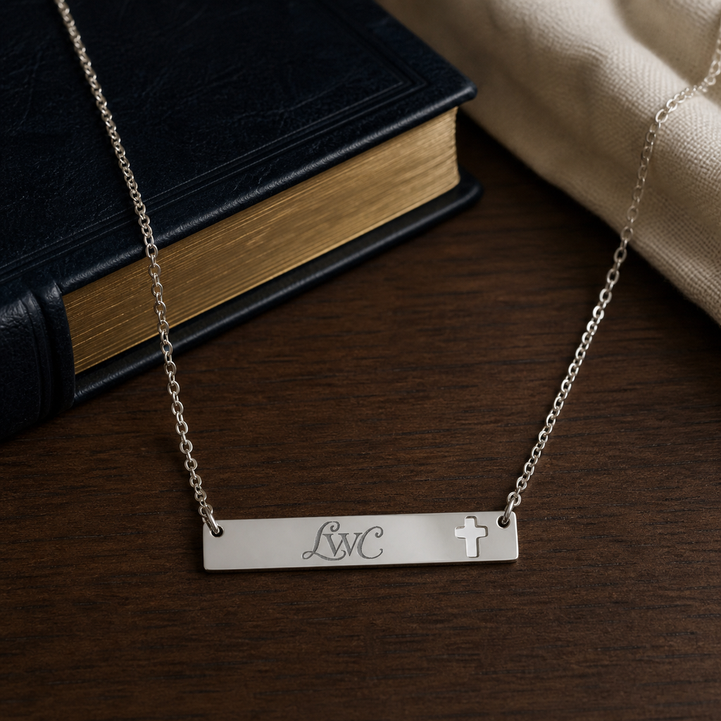 LWC Cross Bar Necklace shown on a premium Bible and walnut table lifestyle setting.
