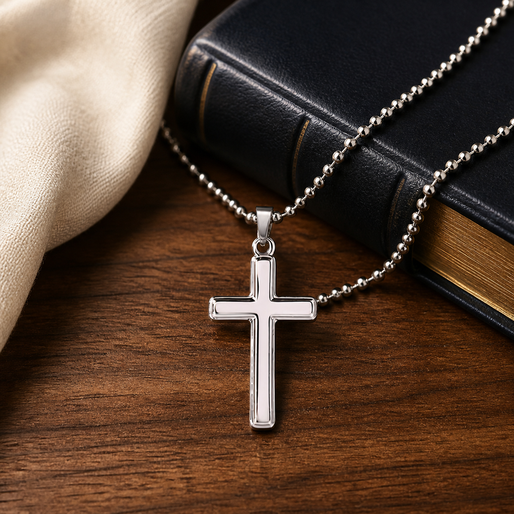 LWC Artisan Cross Necklace shown on a premium Bible and walnut table lifestyle setting.